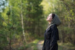 girl woman walking in nature park forest and breathing fresh air. concept of breathing, inhaling, relaxing