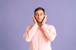 © dikushin - Portrait of calm young man covering ears with hands do not wanna listen standing on pink isolated background in studio with closed eyes. Concept of silence.