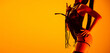 © master1305 - Studio shot of sexy young woman wearing leather lingerie posing isolated on yellow background in neon light. Concept of beauty, love