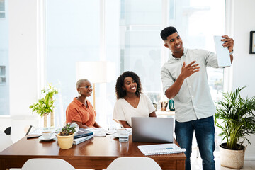 Poster - Technology broadens what they are able to do. Shot of a group of businesspeople using a digital tablet together during a meeting in an office.