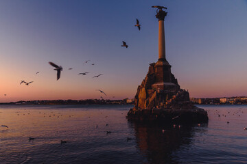 Wall Mural - Monument to sunken ships in Black sea water on sunset. Sevastopol, Crimea