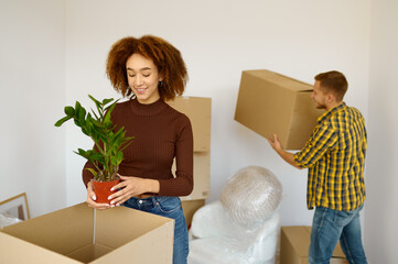 Happy couple packing cardboard box