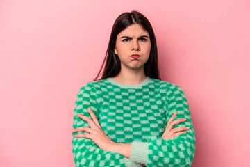 Young caucasian woman isolated on pink background blows cheeks, has tired expression. Facial expression concept.