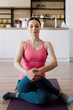 © arthurhidden - Young woman practicing yoga at home on the kitchen background