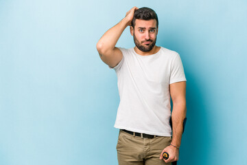 Wall Mural - Young man with crutches isolated on blue background being shocked, she has remembered important meeting.