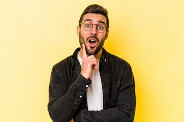 Wall Mural - Young caucasian man isolated on yellow background having some great idea, concept of creativity.