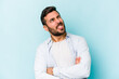 © Asier - Young caucasian man isolated on blue background funny and friendly sticking out tongue.