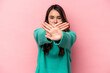 © Asier - Young caucasian woman isolated on pink background doing a denial gesture