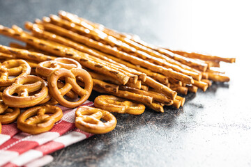 Wall Mural - Mini pretzels and salted sticks. Crusty salted snack on kitchen table.