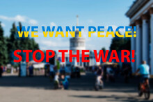We Want Peace - An Inscription In The Colors Of The Ukrainian Flag. War In Ukraine. Blurred Background Of A Peaceful Park. Stop War.
