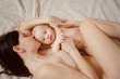 a naked mother and the baby on the bed. maternal and child health. 