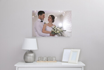 Sticker - Canvas with printed photo of happy newlywed couple on white wall in room