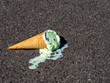 Mint Chocolate Chip Ice Cream cone melting after being dropped onto the ground.