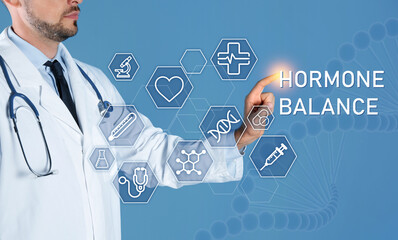 Sticker - Doctor pointing at virtual screen with inscription Hormone Balance and digital icons on light blue background, closeup