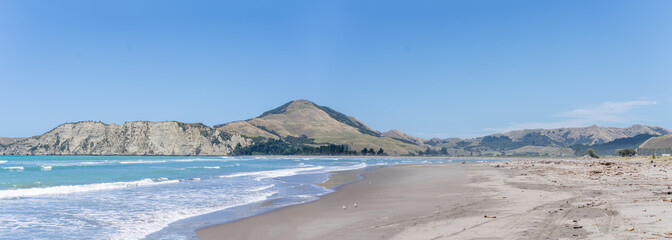 Sticker - Panorama view of Tolaga Bay with surrounding hills under blue sky