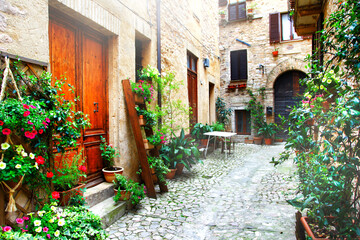 Wall Mural - Charming floral narrow streets of typical italian villages. Spello in Umbria - famous with fllower decorated walls. Italy