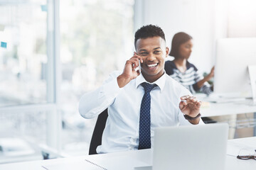 Poster - Things always go according to plan when youve planned ahead. Shot of a young businessman making a phone call at his office desk with a colleague working in the background.