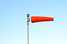 A Windsock Flying In The Wind Against A Blue Sky