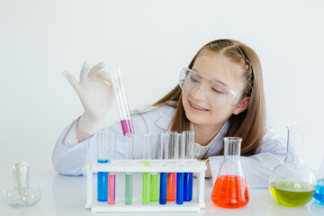 child girl science students study research liquid chemical experiments in white laboratory room. sch