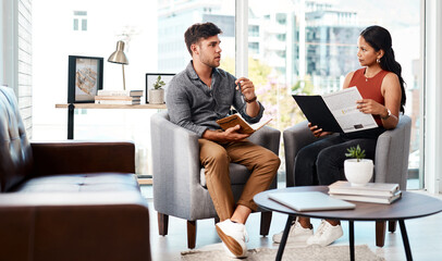 Poster - Running through their game plan from concept to completion. Shot of two young designers having a discussion in an office.