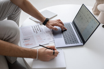 Aufkleber - Hand of young male auditor or analyst looking through document on laptop screen while pressing one of keys of keyboard