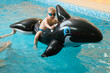 © ninelutsk - Toddler child swimming on inflatable whale on the water. Kid playing and learning to swim dive with equipment and toys in swimming pool in goggles. Boy doing early physicals development activities