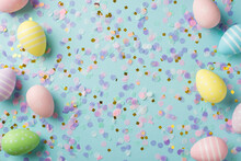 Top View Photo Of Easter Decorations Multicolored Easter Eggs Gold Pink And Violet Confetti On Isolated Pastel Blue Background