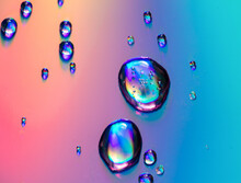 Water Drops On A Rainbow Background.