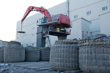 Khabarovsk territory / Russia - 03.22.2018 : Special equipment lifts cargo with raw materials on the territory of a gold mine.