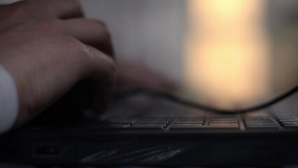 A girl typing on a laptop with a keyboard in Hebrew and English, working from home writing software