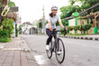 © Odua Images - asian female cyclist in sport clothing and helmet