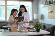 © Prathankarnpap - Two asian girl doing online homework or surfing internet with digital tablet at home.