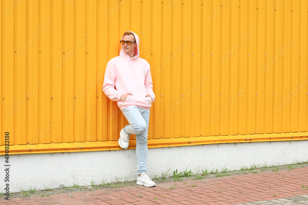 Young guy in stylish hoodie outdoors