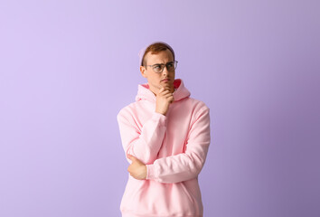 Poster - Thoughtful young guy in stylish hoodie on color background