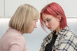 Angry woman and her teen daughter look at each other face to face. Family relationships. Concept confrontation of generations