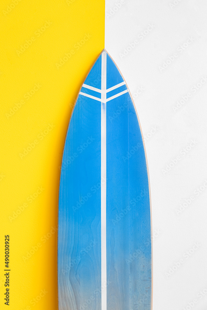 Blue surfboard near wall in room