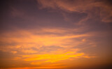Fototapeta Desenie - Evening Sky, twilight dramatic gold sunset dusk background. colorful sunlight cloud sky pastel bright yellow orange backdrop. nature landscape beautiful.