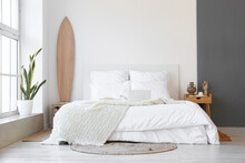 Interior Of Modern Bedroom With Wooden Surfboard And Table