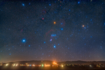 Wall Mural - Landscape and night sky with the Orion Constellation photographed from Wachenheim in Germany.