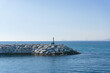 Rock jetty and small lighthouse in the seaport of Premia de Mar