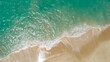 © panya99 - Aerial view sandy beach and crashing waves on sandy shore Beautiful tropical sea in the morning summer season image by Aerial view drone shot, high angle view Top down