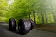 Change a car seasonal tire summer forest road with trees background. Change for winter tire. Banner Selling off. Or Background automechanic 