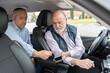 © Renata Hamuda - middle-aged passenger in back seat paying with credit card to elderly driver-concept of transportation, cab,taxi and technology