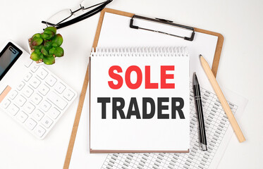 Poster - Office desk table with paper sheet, notepad ,chart and calculator. Top view SOLE TRADER
