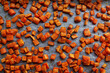 Oven roasted carrots and sweet potatoes on a parchment paper, cut into cubes