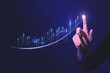 Close up of hand pointing at glowing business chart on dark blue background. Stock, market and trade concept. Double exposure.