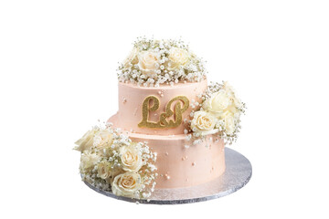 Wedding pink cake from two floors, with roses on a stand on a white background. letters l, p