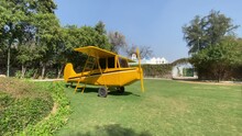Shot Of Beautiful Small Vintage Yellow Airplane Kept On A Farmhouse In Delhi, India.