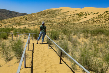 A girl on the territory of the Sarykum sand reserve. The desert in Dagestan. Russia. 2021.