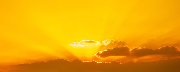 Wall Mural - cloud and sunlight sunbeam or sunrays through the sky at sunset or evening time.